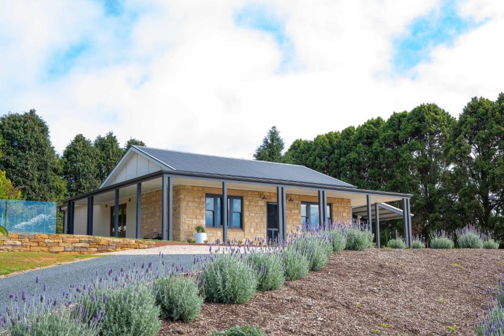 a house in a garden with plants at Adelaide Hills luxury cottage spectacular views in Summertown