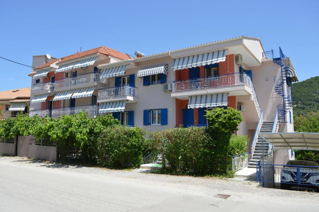 a building with balconies on the side of a street at Emilios Eleni studios in Nydri