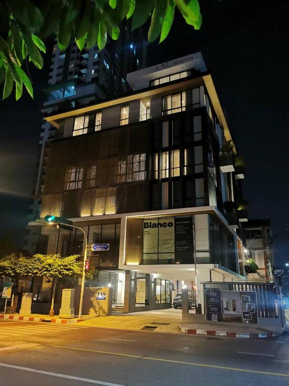 a building on a city street at night at Tay Residence in Bangkok