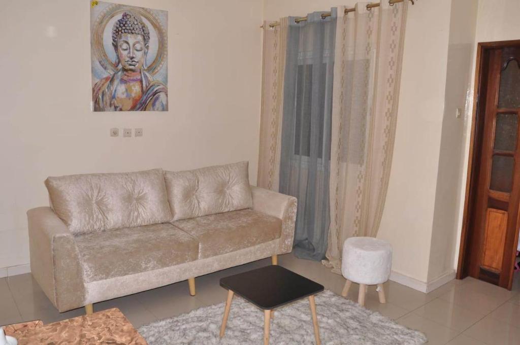 a living room with a couch and a painting on the wall at Dakar Top destination 2 in Dakar