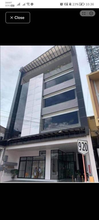 a tall building with a sign in front of it at Quirino hub (404) in Davao City