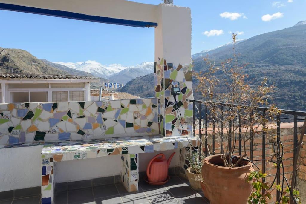 a balcony with a view of the mountains at The Tile House in Güéjar-Sierra