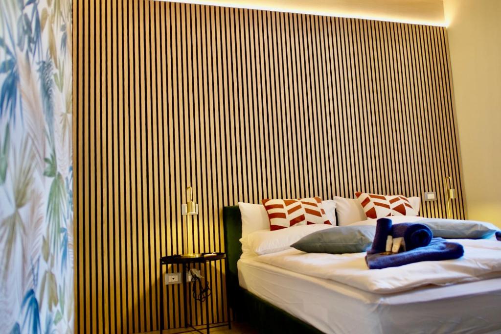 a bedroom with a bed with a wooden wall at LOFT TIRANO 3 minuti dal Bernina Express in Tirano