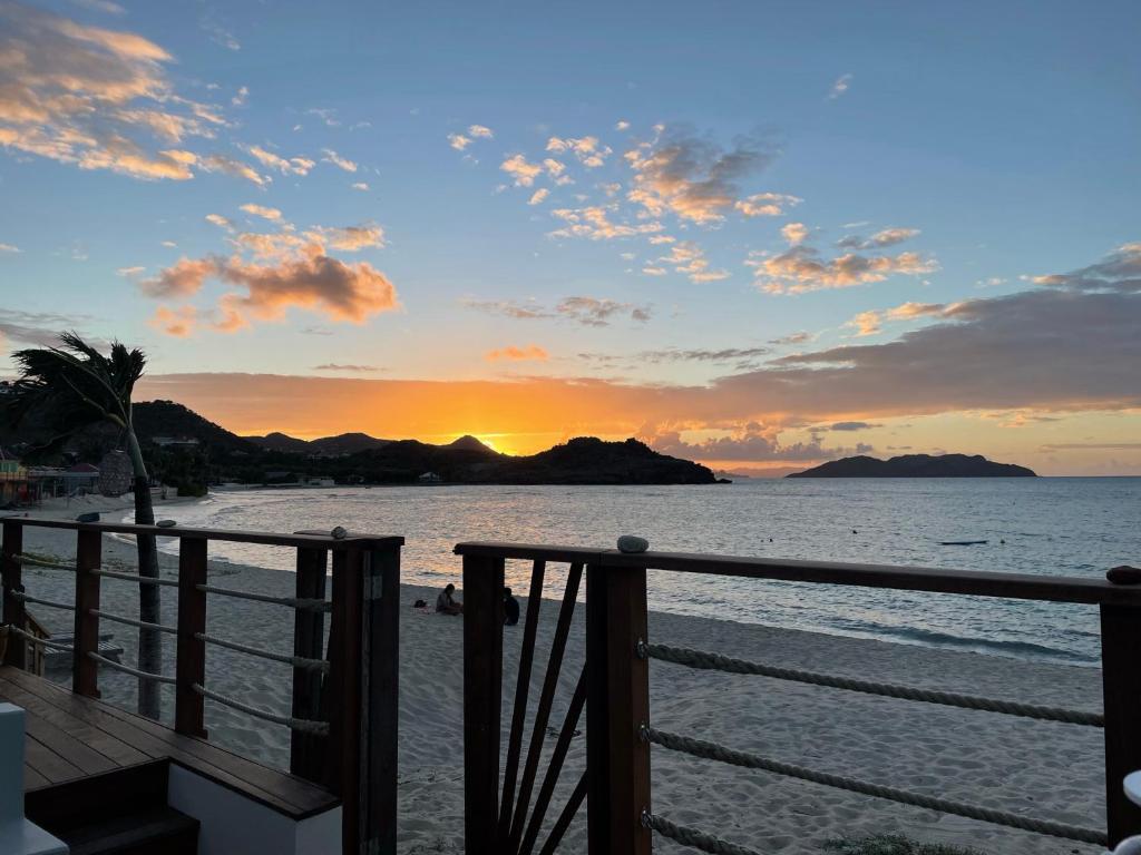 a view of the beach at sunset from a balcony at Villa Yvantino in Saint Barthelemy