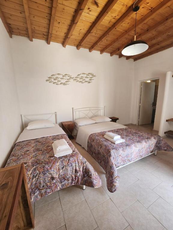 Postel nebo postele na pokoji v ubytování Hotel Kastelakia Mykonos