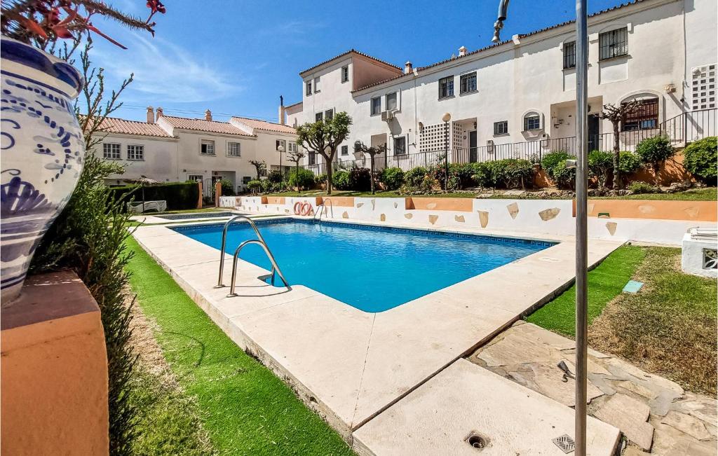 a swimming pool in front of a building at Stunning Home In Torre De Benagalbon With Outdoor Swimming Pool in Torre de Benagalbón
