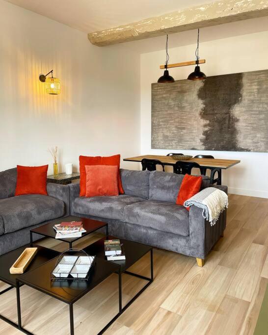 a living room with a couch and a table at Appartement de prestige à Saint-Rémy-de-Provence in Saint-Rémy-de-Provence