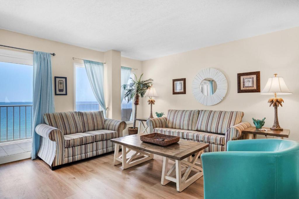 a living room with two chairs and a table at The Summit 1502 in Panama City Beach