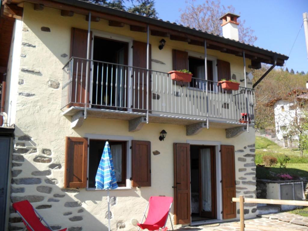 a house with a christmas tree on the balcony at Casetta dei Lupi in Miazzina