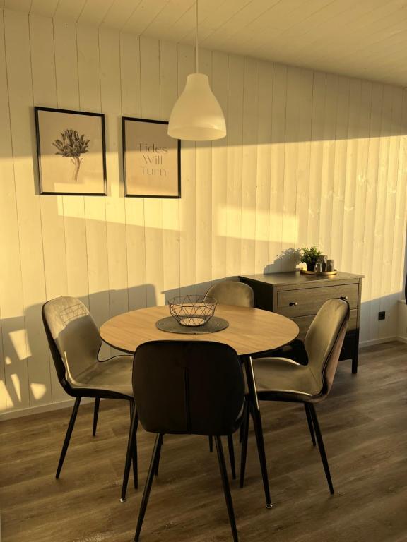 a dining room with a table and chairs at Aitvarai 41 in Svenele