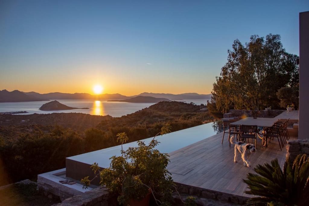 a villa with a view of the ocean at sunset at The Boatyard Luxury Villa in Tzíkidhes