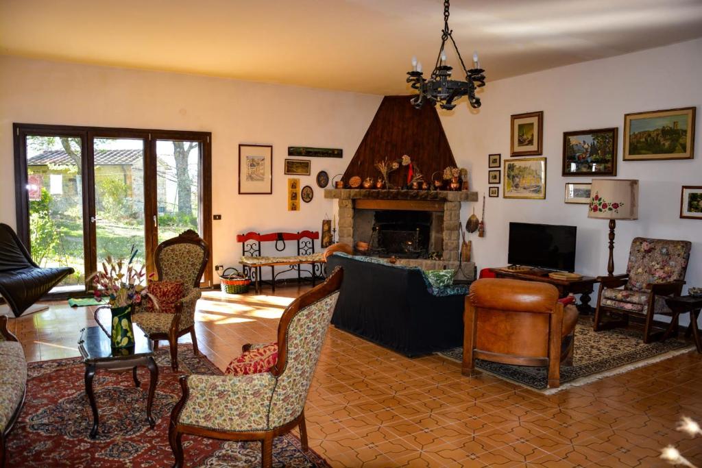 a living room filled with furniture and a fireplace at La Casa di Cesarina in Celle sul Rigo