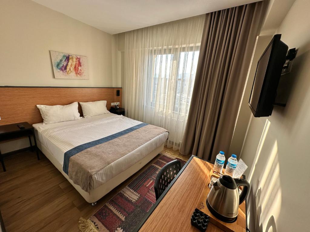 Postel nebo postele na pokoji v ubytování N'Ala Otel