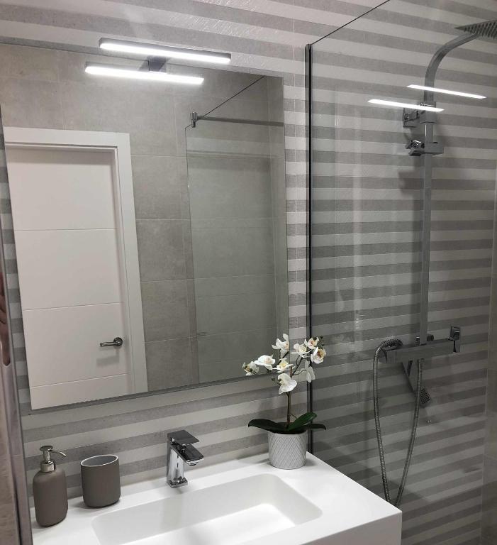 a bathroom with a sink and a mirror at Villa El Buzo in Zahara de los Atunes