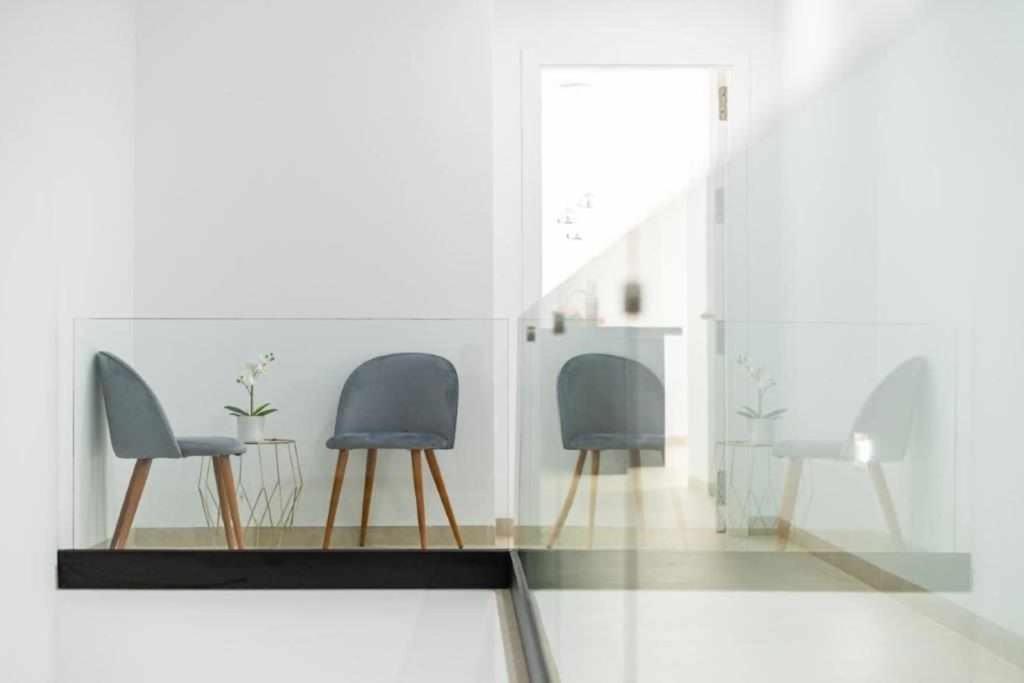 a room with two chairs and a glass table at Villa El Buzo in Zahara de los Atunes