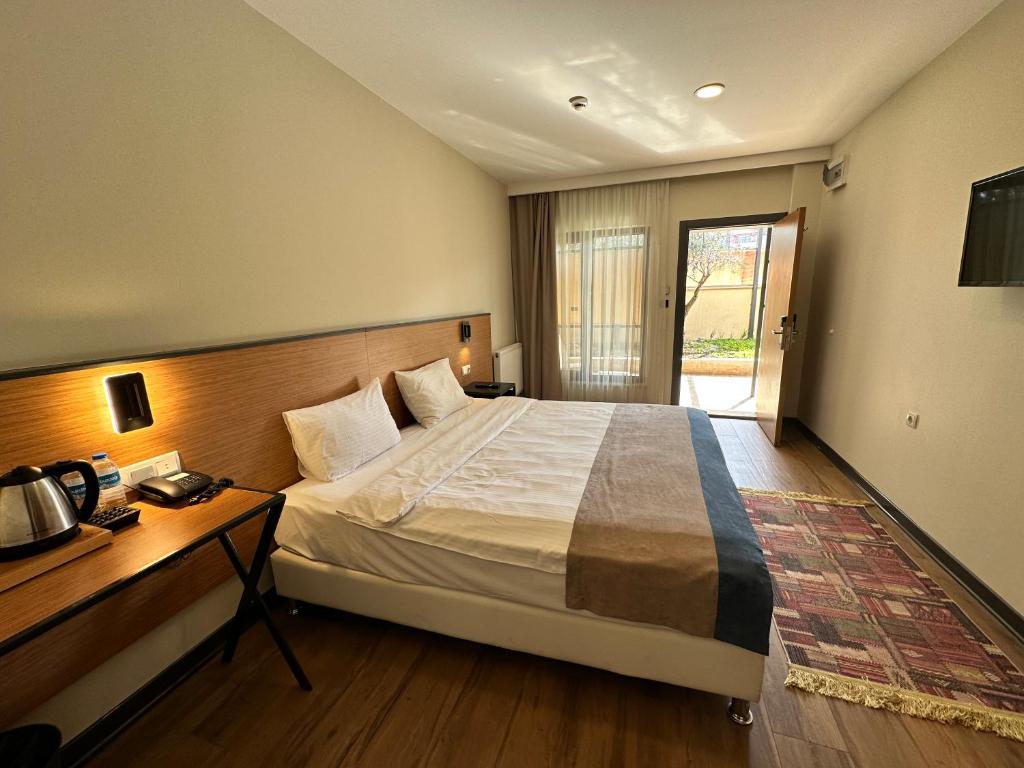 Postel nebo postele na pokoji v ubytování N'Ala Otel