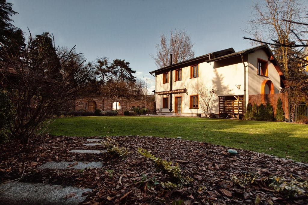 a large white house with a grass yard at Constantia by Grape Hotel in Wrocław