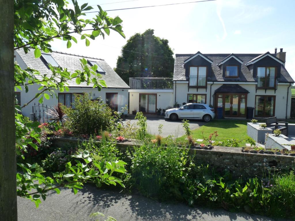 a house with a car parked in front of it at Gwyndaf Bed And Breakfast in Beaumaris