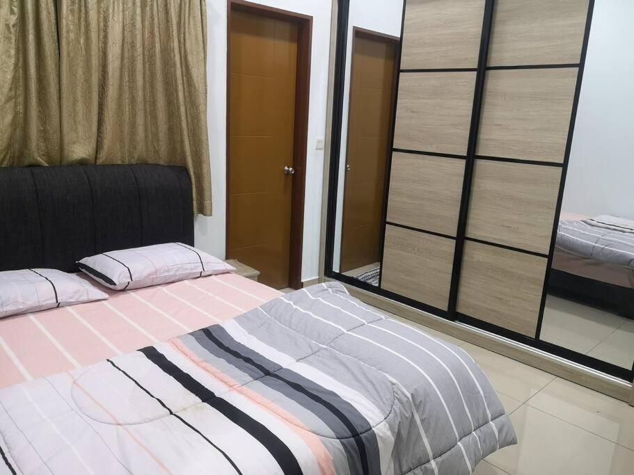 a large bed in a room with a window at Livin Hub @ Bandar Sri Sendayan in Sendayan Village