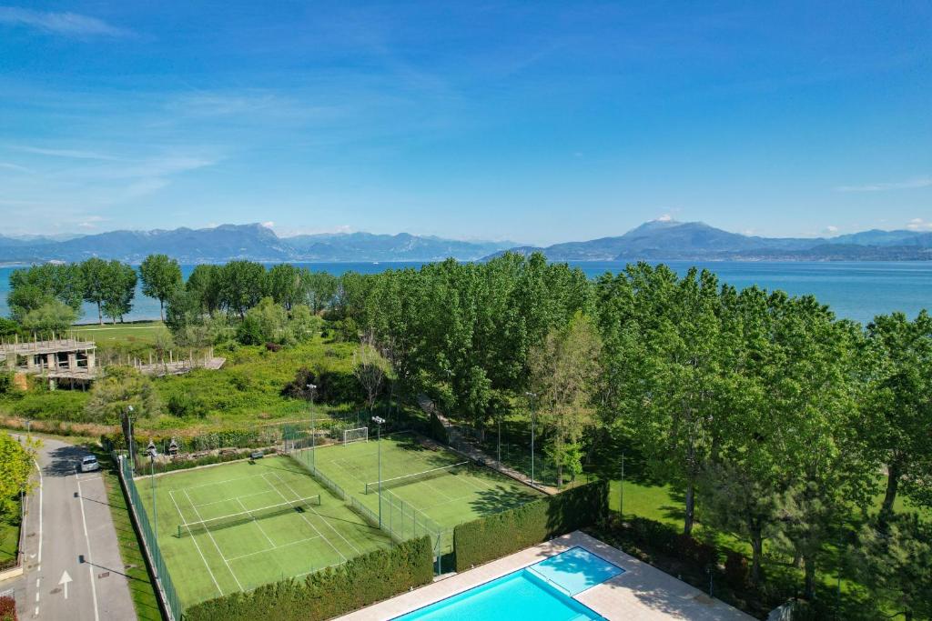an aerial view of a tennis court with a tennis racket at Acquarius Resort Sirmione - MGH in Sirmione