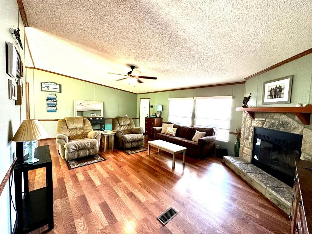 a living room with a couch and a fireplace at Orange Beach! Spacious mobile home near the beach! in Orange Beach