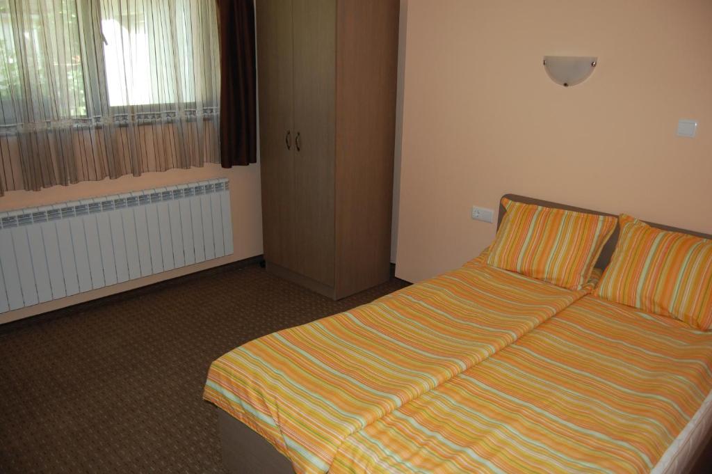 A bed or beds in a room at Guest House Savina