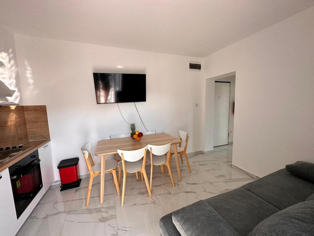 a kitchen and dining room with a table and chairs at Timm apartment -1bedroom in Vir