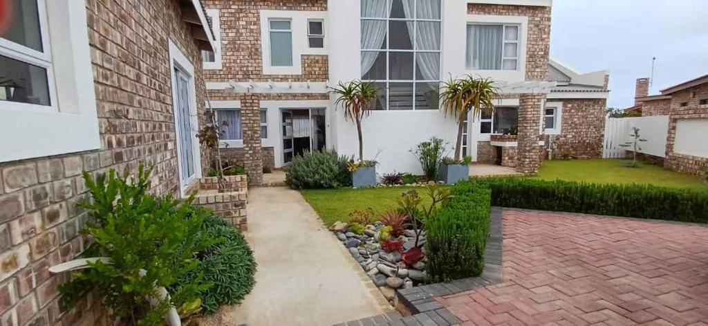 a house with a garden in front of it at Sunbay in Hentiesbaai