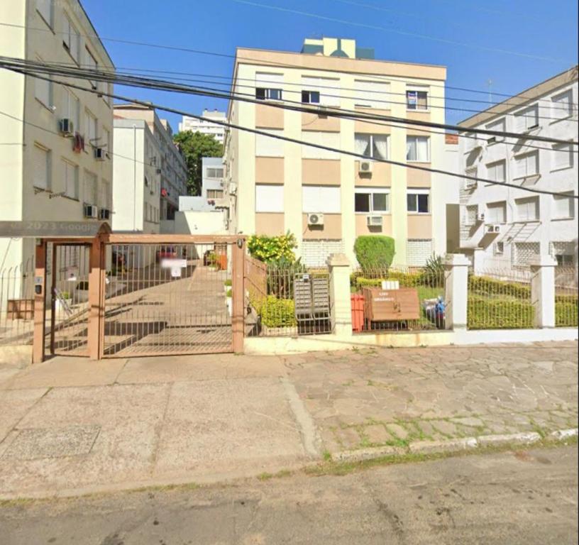 a building with a gate and stairs in a city at Apt próximo ao Consulado in Porto Alegre