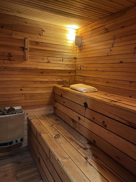 an empty wooden sauna with a bench in it at Gîte Framboisier au Château des Pauses in Saint-André-de-Majencoules
