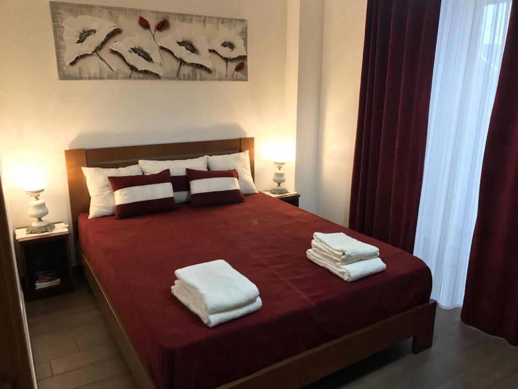 a bedroom with a bed with towels on it at JAC-Lovely new apartment in Horta Faial Island in Horta
