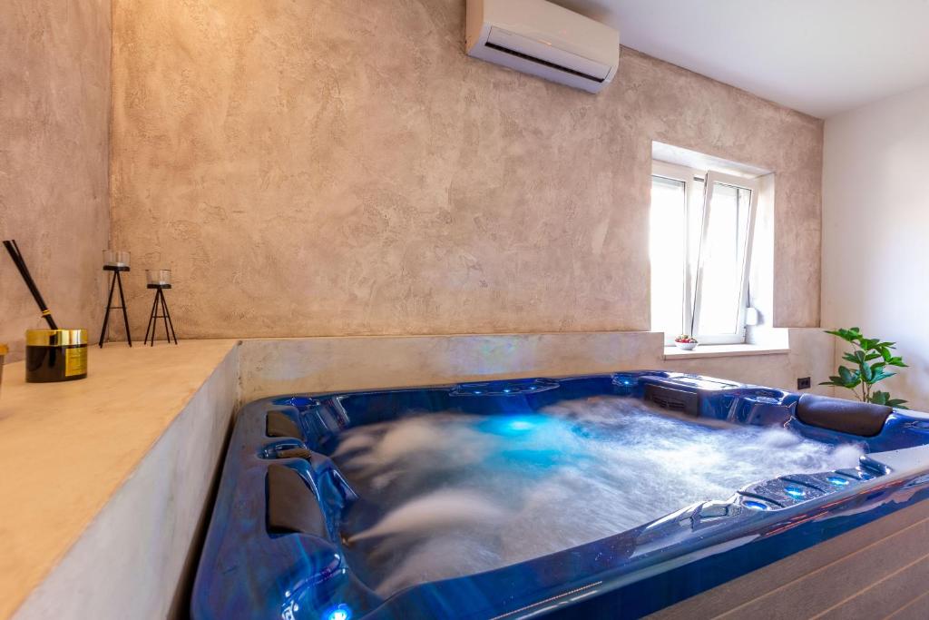 a large jacuzzi tub in a room at Luxury Hedone Apartment near the Bridge with Private SPA Zone in Zadar