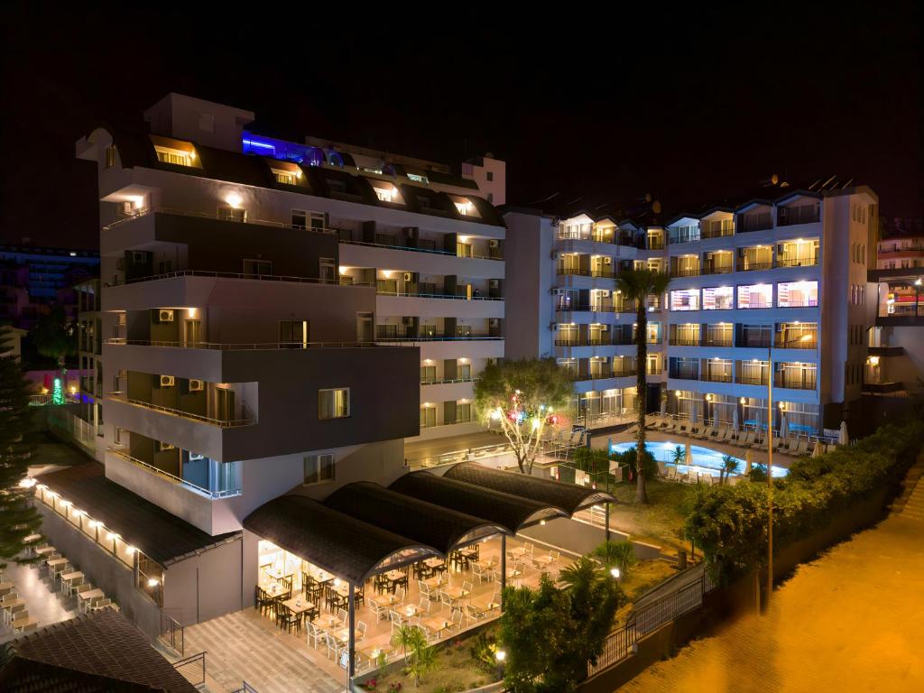 a building with a pool in front of it at night at Akdora Elite Hotel & Spa in Side