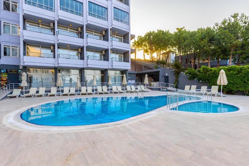 a swimming pool in front of a building at Akdora Elite Hotel & Spa All Inclusive in Side