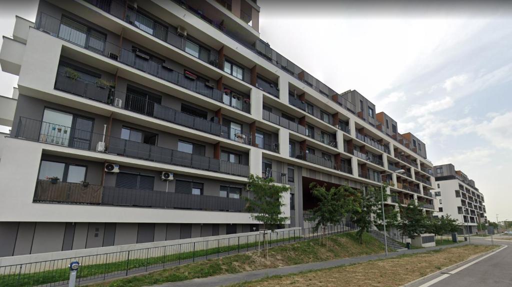 an apartment building on the side of a street at 1 room Apartment with terrace, Slnečnice in Bratislava