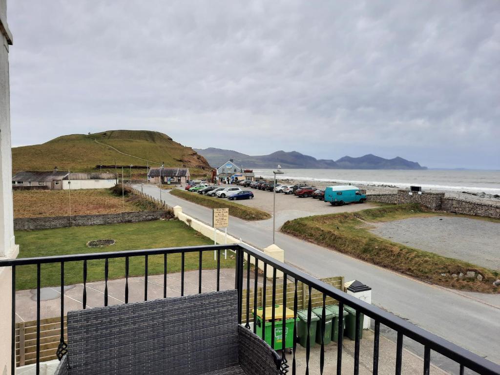 a balcony with a view of a road and the ocean at Wendon Holidays in Caernarfon