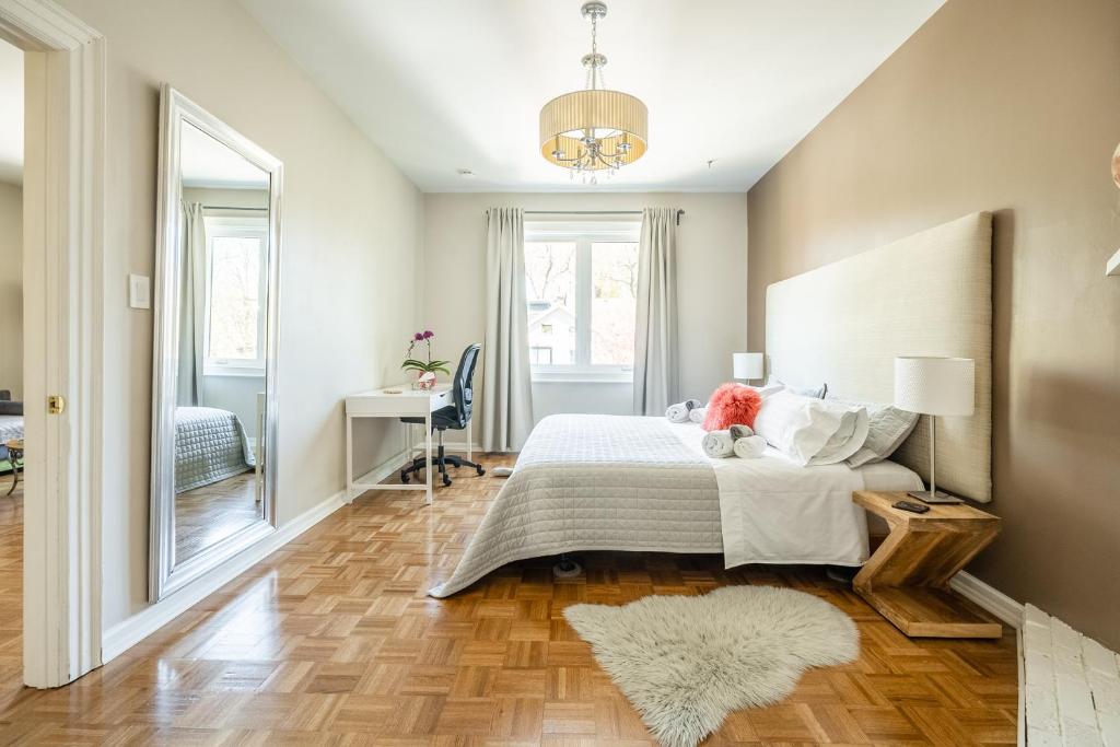 a bedroom with a large bed and a rug at Gabby's Place Downtown Core in Toronto