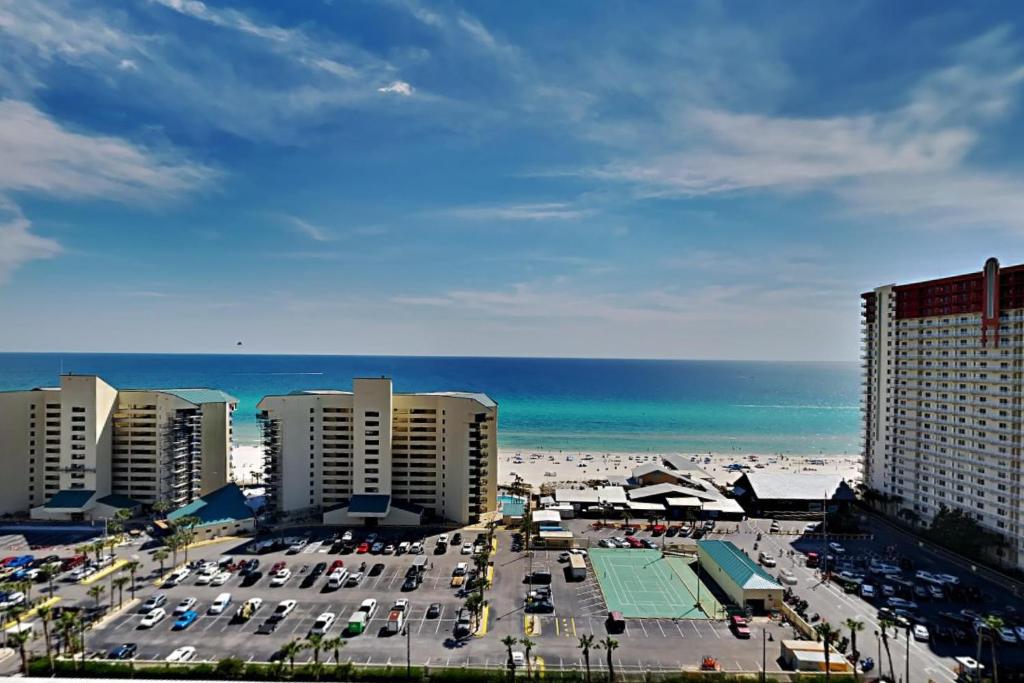 a parking lot at the beach with buildings and the ocean at Laketown Wharf 1523 in Panama City Beach