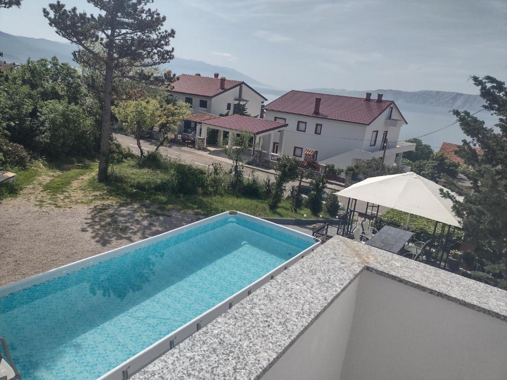 a swimming pool on the roof of a house at Apartments Vita in Novi Vinodolski