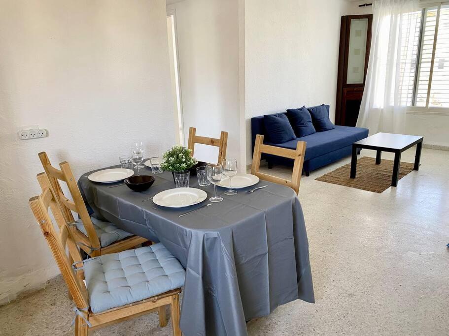 uma sala de jantar com uma mesa com uma toalha de mesa azul em Уютная квартира с двумя спальными em Qiryat H̱ayyim