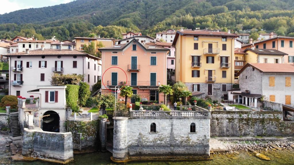 a view of a town on the water with buildings at Villa Lina in Lezzeno