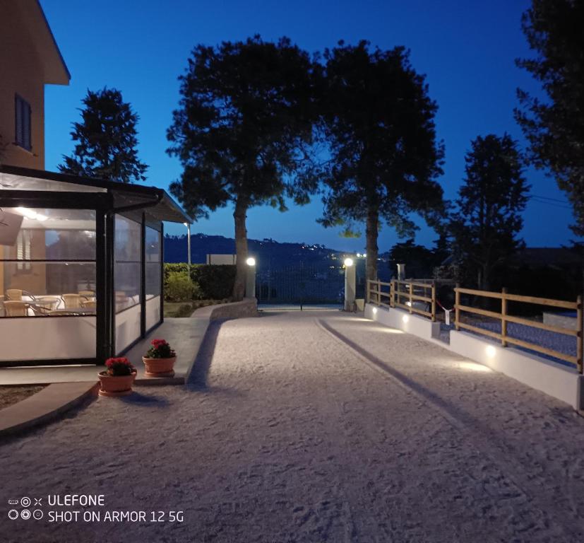 a night view of a walkway with a building at Casale Ermo Colle in San Filippo