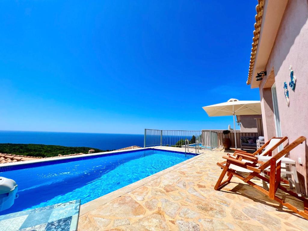 a swimming pool with a view of the ocean at Villa Dioni in Fiskardho
