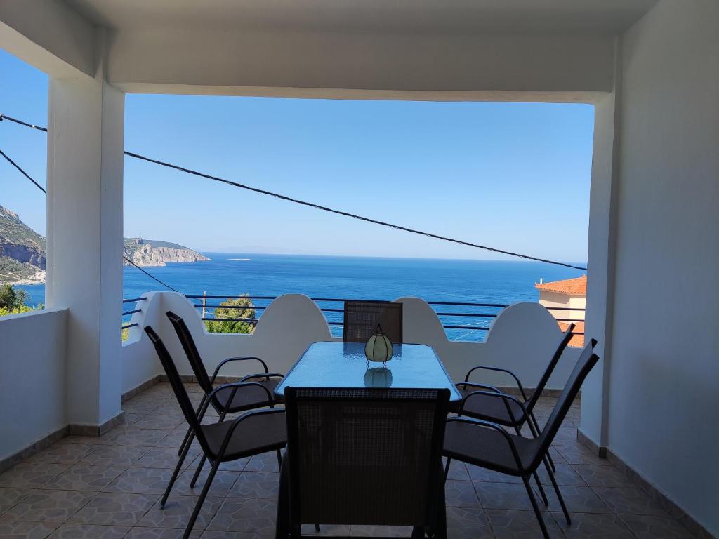 a dining room with a view of the ocean at Amazing View in Akhladherí