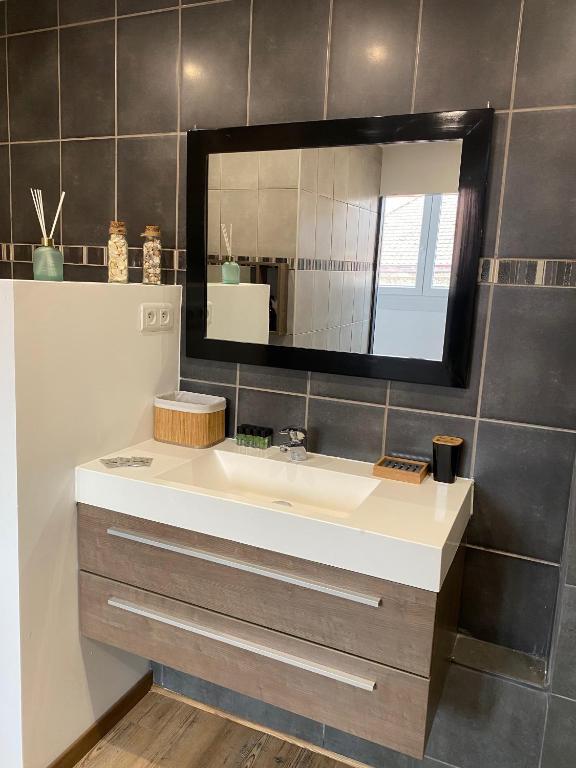 a bathroom with a sink and a mirror at Superbe appartement F4 au cœur de Malo-les-bains in Dunkerque