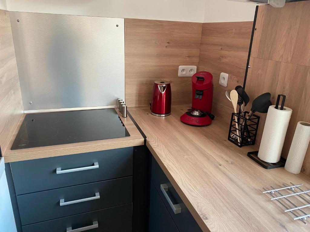 a kitchen counter with a sink and a red appliance at Superbe appartement F4 au cœur de Malo-les-bains in Dunkerque