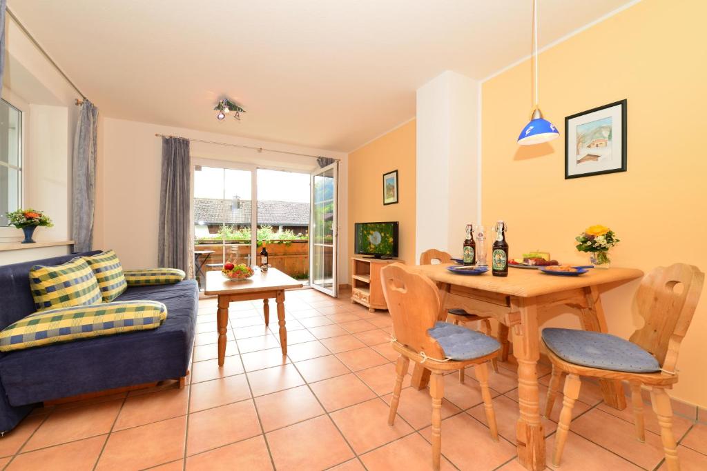 a living room with a table and a couch at Ponyhof Schöllang in Oberstdorf