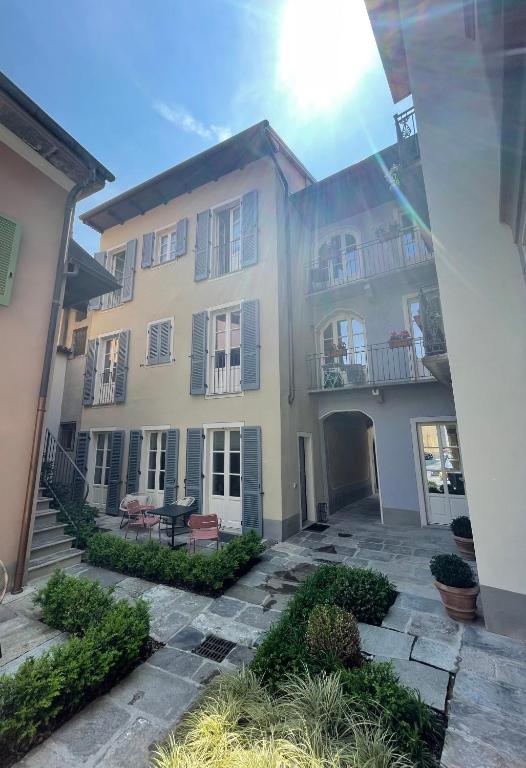 a large white building with a patio in front of it at Casa Cristina in Cannobio