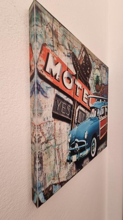 a painting of a car hanging on a wall at Anna Garden Sidari in Sidari