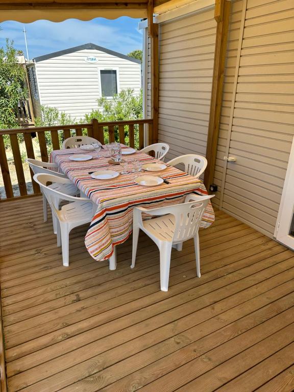 a table and chairs sitting on a deck at Mobile Home de standing in Canet-en-Roussillon